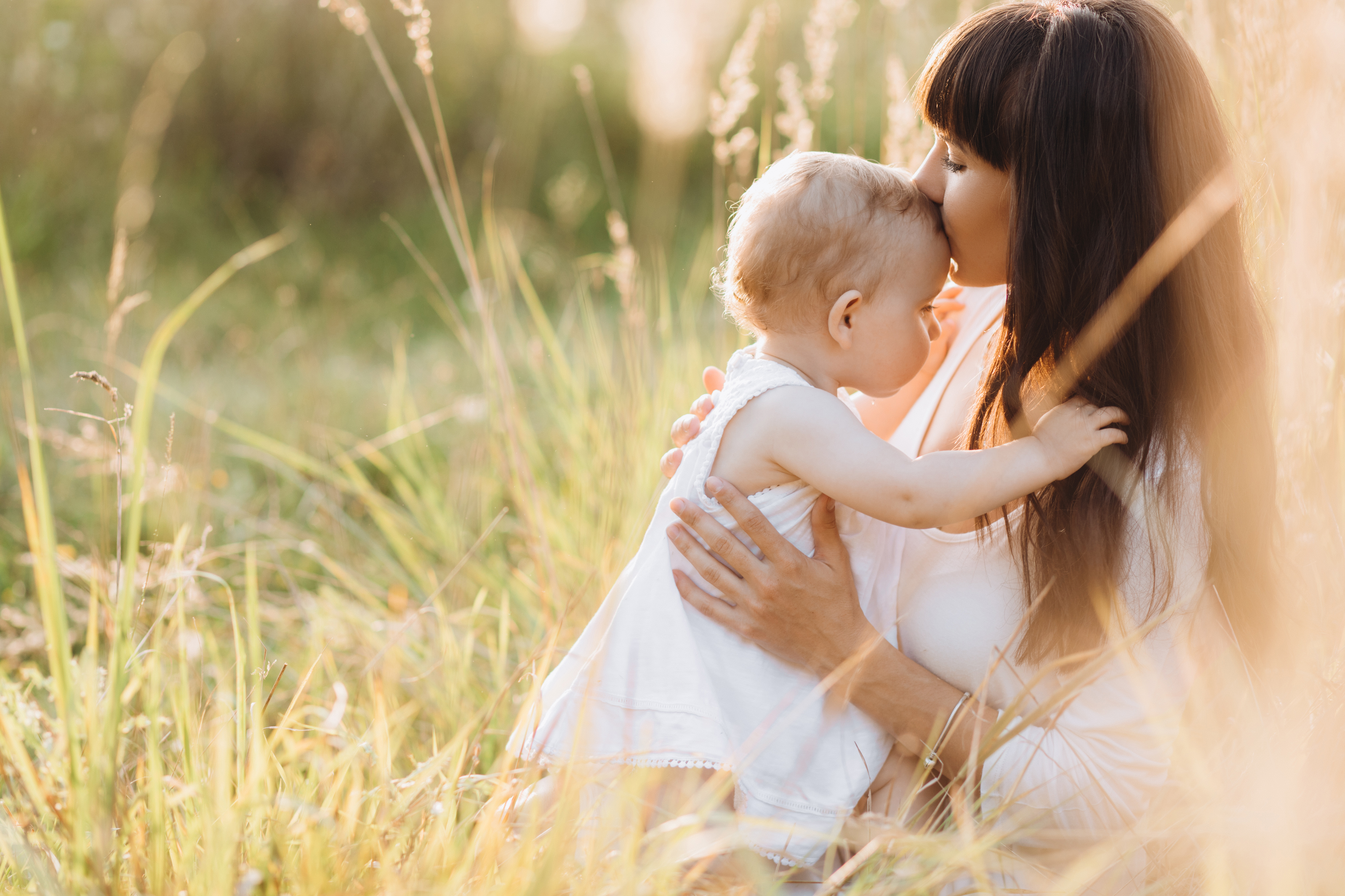 A mother and her daughter walking across a field