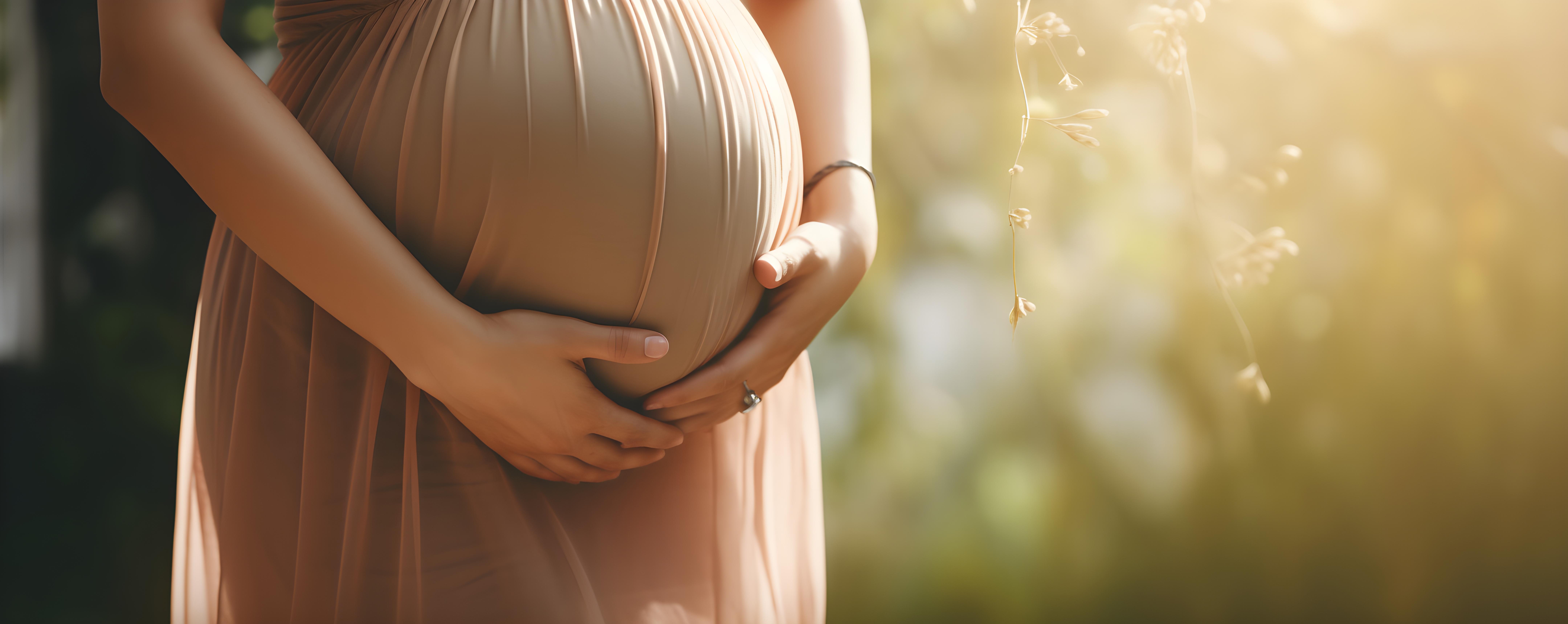 A close-up of an expectant mother cradling her bump